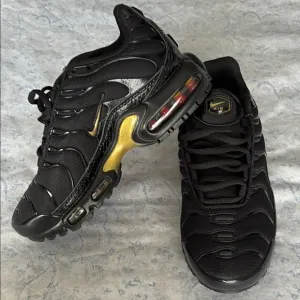 Nike Kid’s Black and Gold Sneakers
