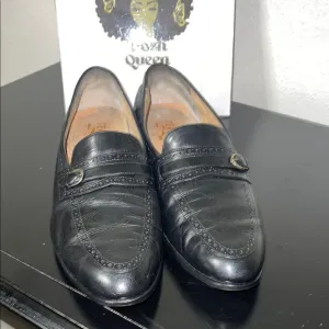 Salvatore Ferragamo's black leather loafers.